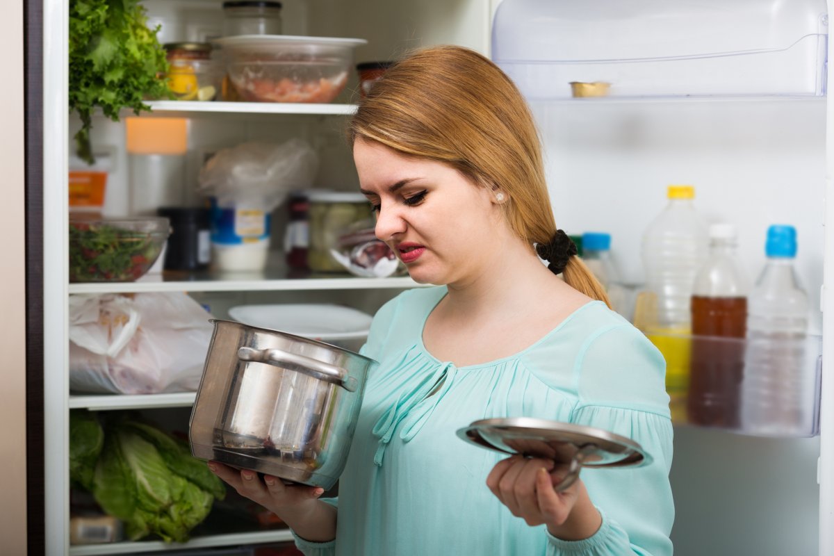 A woman notices foul-smelling food