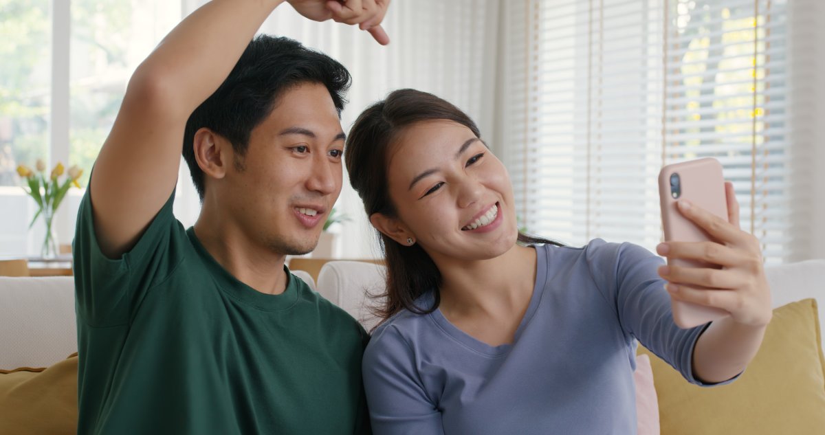 A couple takes a video on smartphone
