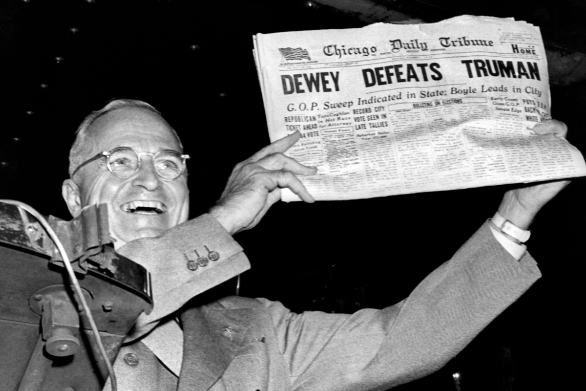 President Harry Truman holds up a newspaper
