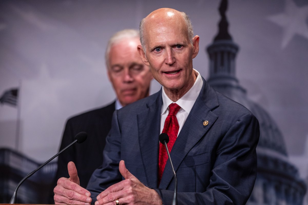 Rick Scott speaks to reporters
