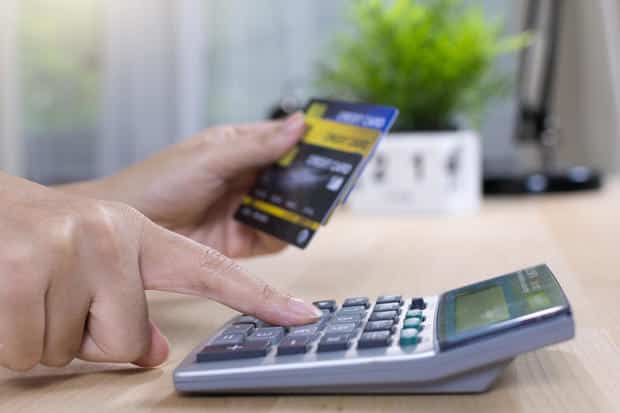 woman calculate how much cost or spending have with credit cards 