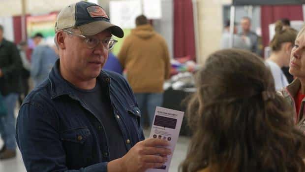 Al Schmidt talks to voters at a county fair 