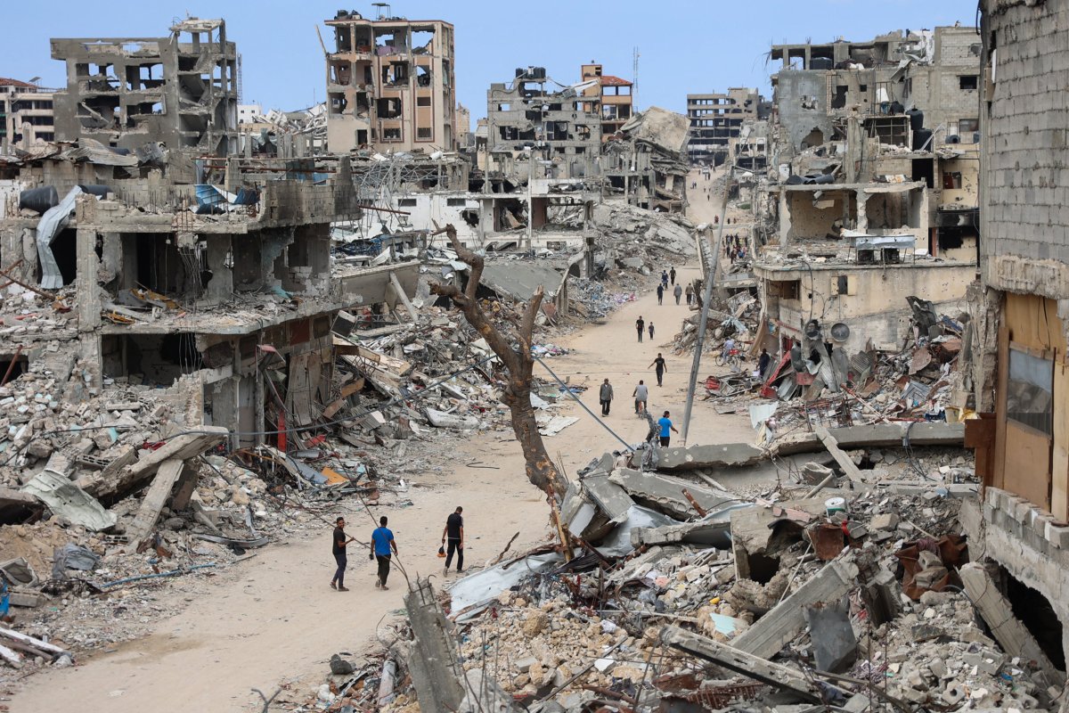 Palestinians, walk, through, destroyed, Shujaiya, neighborhood, Gaza