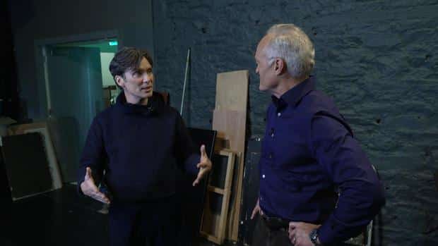 Cillian Murphy and Scott Pelley in a theater 