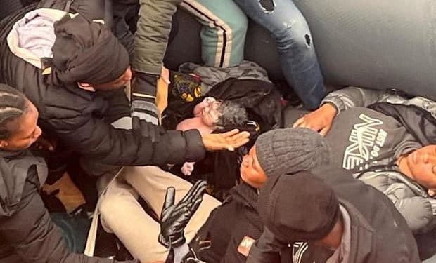 Photo shows rescue of baby girl born at sea on migrant ship