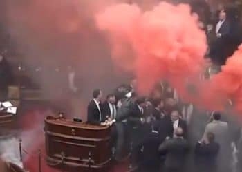 Serbian parliament erupts into chaos as smoke grenades, tear gas clash ensues