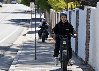 Is this high speed vehicle going the wrong direction on the sidewalk a bicycle or a jeopardy to pedestrians?